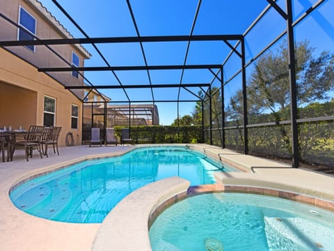 elax in a sparkling private pool under a screened patio—perfect for sunny days and cozy evenings!