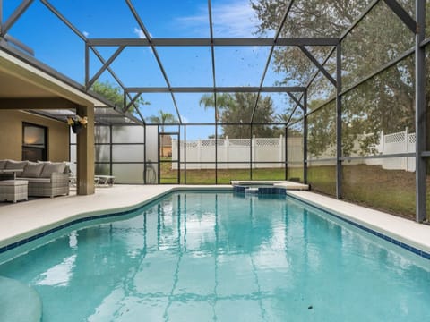 Spacious pool area with screened enclosure, perfect for relaxing or hosting outdoor gatherings.