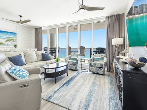 Sink into plush seating while soaking up breathtaking ocean views from your private balcony in this bright, airy living space.
