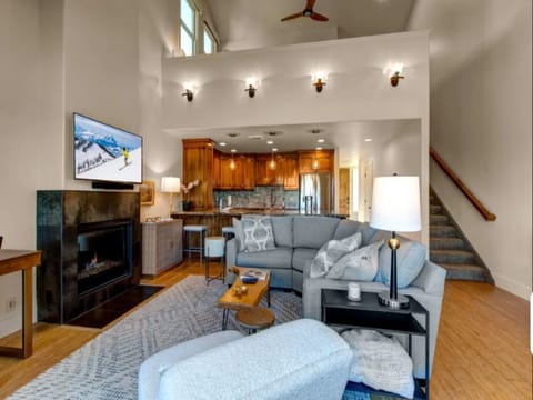 Open-concept living room offers a gas fireplace, seamlessly connected to the kitchen for easy entertaining and relaxation.