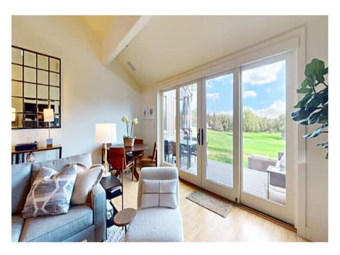 Cozy living room offers plush seating, 50” smart TV, gas fireplace, work desk, access to a private deck