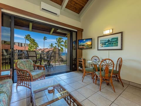 Your bright, open living and dining space flows seamlessly to a private lanai overlooking swaying palms and ocean views, inviting you to relax and unwind in tropical island comfort.