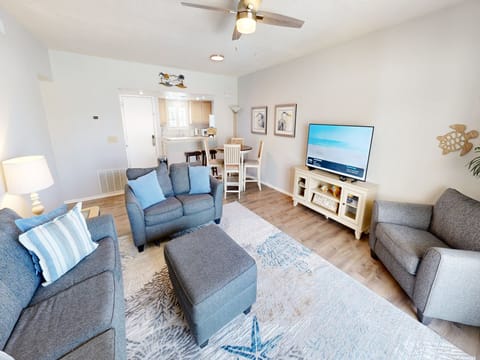 Unwind in your bright, beach-inspired living space with cozy seating, coastal charm, and all the comforts of home waiting for you.
