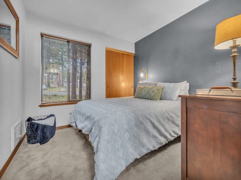 Bedroom with Queen size bed and ample storage in dresser drawers and closet for guest storage