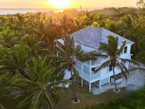 The Guest House at Hibiscus Hill seen from above as the sun dips into the bay