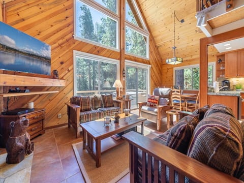 Large windows fill the space with natural light and frame breathtaking views of the beautiful Tahoe forest.