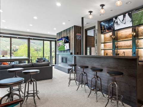 The sports bar with three TV's and the second living room with three TV's and large sectional sofa.