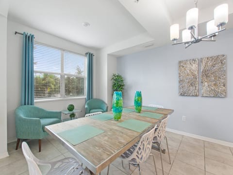 Bright open-concept dining area with glass-top table and seating – Shine Villas | Sunset Retreat, Storey Lake Resort, Orlando