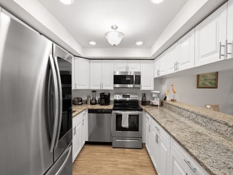 Modern kitchen with stainless steel appliances and ample counter space.
