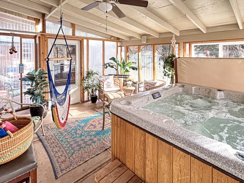 Soak your worries away in your private hot tub while enjoying panoramic views through floor-to-ceiling windows. The cozy hammock and lush plants create a tropical oasis where you can truly unwind and reconnect.