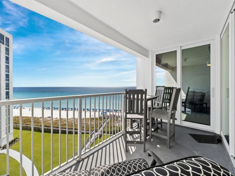 Your private balcony offers stunning oceanfront views while you relax in comfortable seating, watching beach life unfold below.