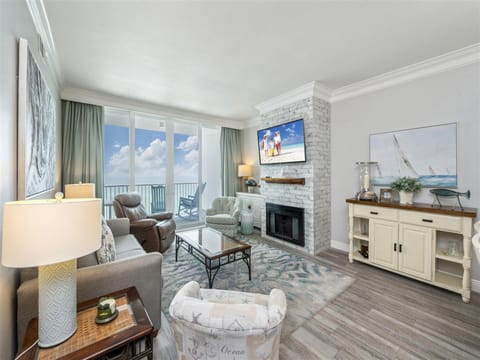 Unwind in your elegant living room with stunning ocean views, cozy fireplace, and coastal-themed décor perfect for relaxing after beach days.