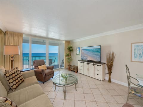 Relax in your oceanfront living room with stunning sea views and beach scenes on the wall-mounted TV.