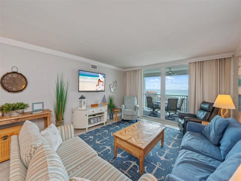 Unwind in your bright oceanfront living room with plush seating, nautical touches, and stunning balcony views that invite endless relaxation.
