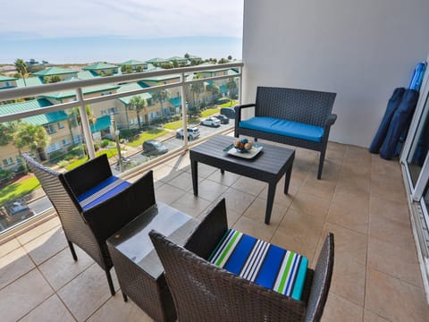 Your private balcony with comfortable seating overlooks the charming neighborhood and features a coffee table perfect for morning drinks or evening relaxation.