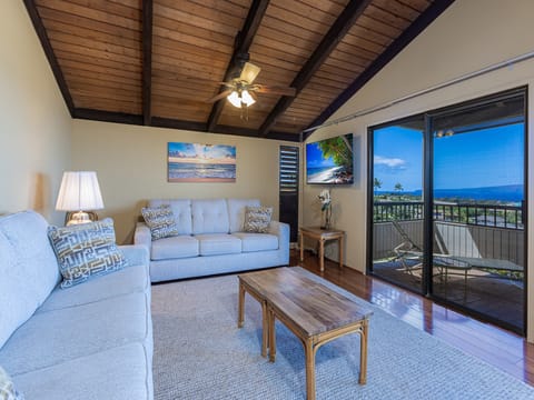 Relax in your ocean-view living room with plush seating, and stunning blue waters stretching through your private balcony.