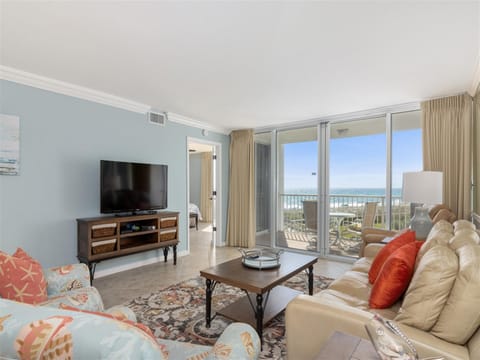 Unwind in your bright living room with ocean views, plush seating, and coastal charm perfect for relaxing after beach days.