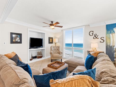 Unwind in your elegant living room where plush sectional seating and ocean views create the perfect retreat for relaxation.