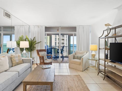 Relax in your bright coastal living room where ocean breezes flow through sliding doors to your private balcony overlooking stunning sea views.