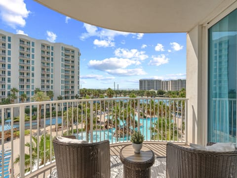 Step onto your private balcony and soak in stunning pool views framed by swaying palms and sunny skies—your perfect spot for morning coffee or evening relaxation.