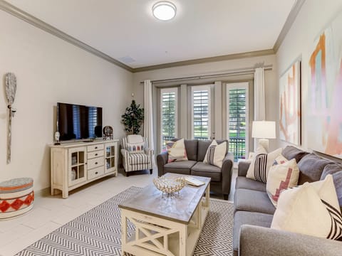 Settle into your cozy living space, where plush seating and natural light create the perfect spot to unwind after a day of exploring. The thoughtfully designed room invites you to relax with family or simply enjoy a quiet evening in.