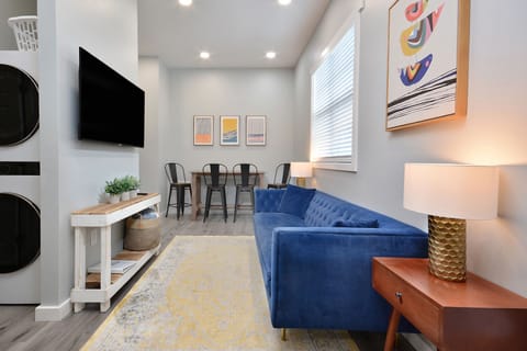 Living space: 55" TV, couch, side tables, bar table