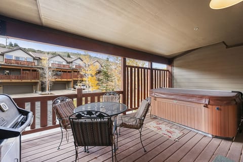 Cozy Seating Around the Large Hot Tub and View of Surrounding Hills from Covered Deck Just Off Kitchen