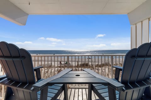 Private balcony with sweeping ocean views—sunsets from Adirondack seats.