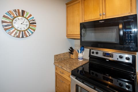 Kitchen includes plenty of pots, pans, and cooking utensils