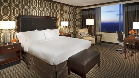 Unwind in a plush king bed with sparkling sunset views.