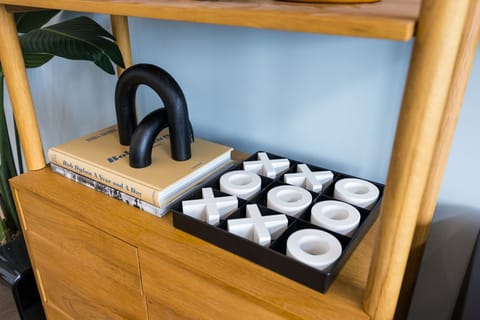 Main Level: Bright open floor living area featuring a large smart flat-screen TV, designer furnishings, and entrance to a large private patio.