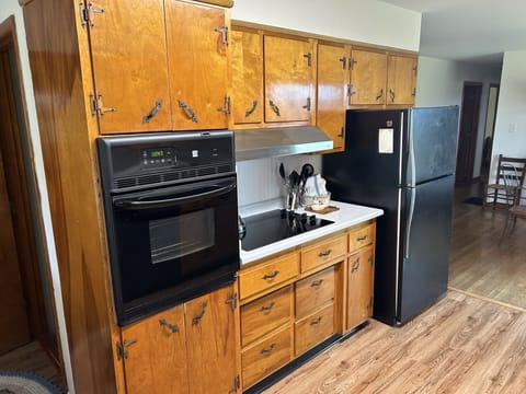 The kitchen is fully stocked with coffee maker and cooking and eating utensils.