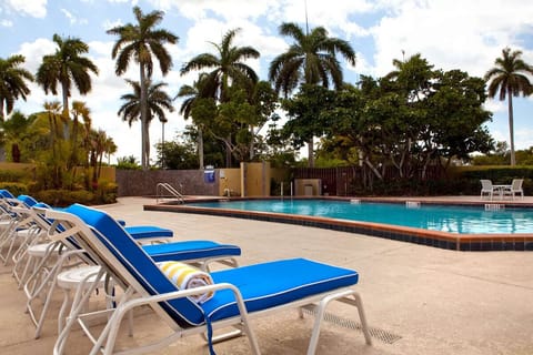 Lounge poolside under palms and soak up vacation calm.