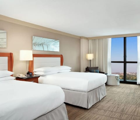 Settle into crisp double beds beside expansive skyline windows.