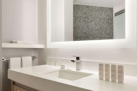 Refresh at a spa-clean vanity with bright mirror lighting.