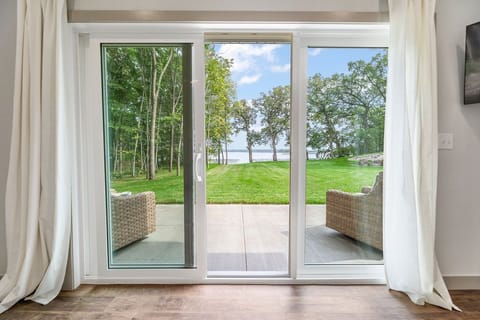 Primary suite views of patio + lake