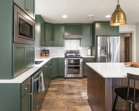 Well equipped kitchen with double oven, cooktop, fridge, dishwasher, microwave.