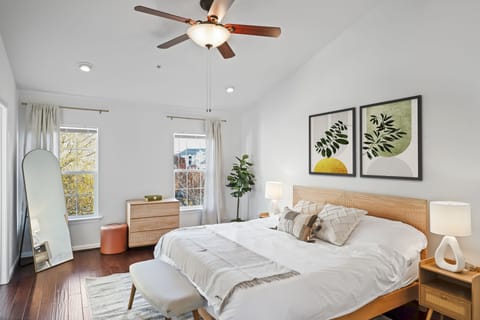 Dream in this serene primary bedroom. Modern art meets cozy comfort.