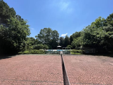The tennis court next to the pool where you can play with your family & friends.