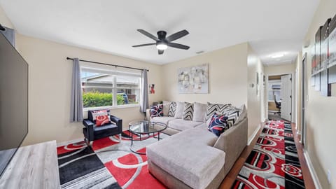 Bright living room with 75" Roku TV and work-ready Wi-Fi