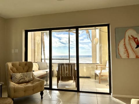 Gulf front, screened in lanai with comfy furniture and ceiling fan. Direct view.