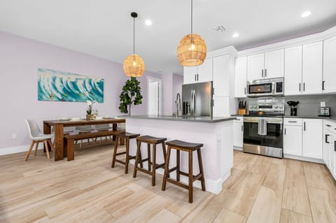 This dining space seamlessly integrates with the open-plan kitchen, making it easy to transition from cooking to dining. Additional bar stool seating at the kitchen island allows for extra dining space.