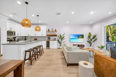 The open plan layout connects the kitchen seamlessly to the dining and living areas, allowing for easy flow and interaction with guests. It's perfect for hosting dinner parties, family gatherings, or simply enjoying the company of loved ones while prepari