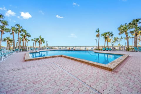 Relax poolside with sweeping views of palm trees and the coastline.