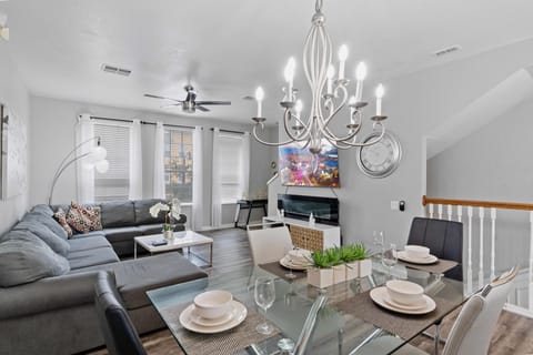 - Chic dining area of the townhouse in Orlando - Featuring a stylish table and contemporary seating - Thoughtful lighting fixtures creating an intimate and inviting atmosphere - 6 persons dining under a majestic chandelier