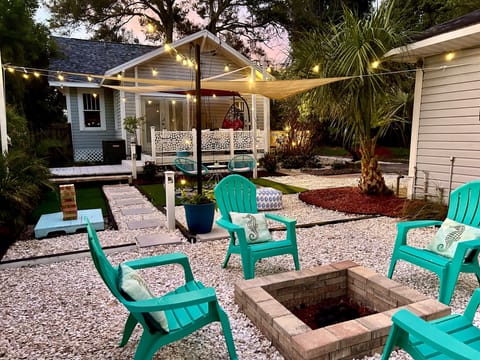 Backyard entertainment area. Fire pit, shade sails and seating