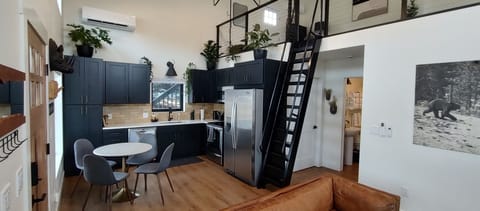 Kitchen with full size appliances & seating for four.