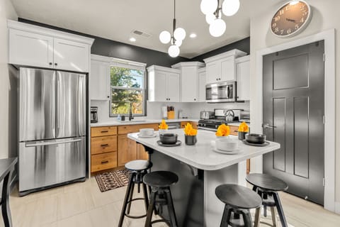stylish kitchen with quartz countertops, gas stove with large oven. large air fryer and all hand appliances needed for your family meal preparation.