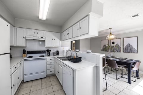 Bright kitchen with pass-through bar and adjacent dining area