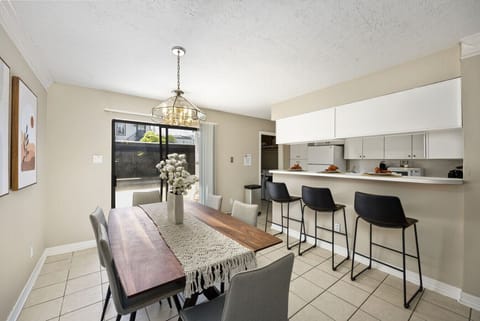 Spacious dining area with island bar seating, ideal for gathering and shared meals